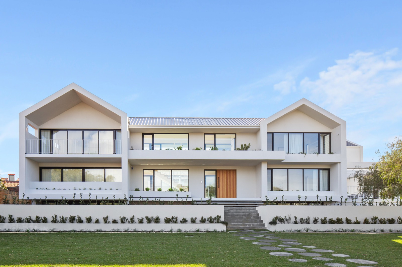 City Beach new build with gabled forms and a carefully landscaped front garden