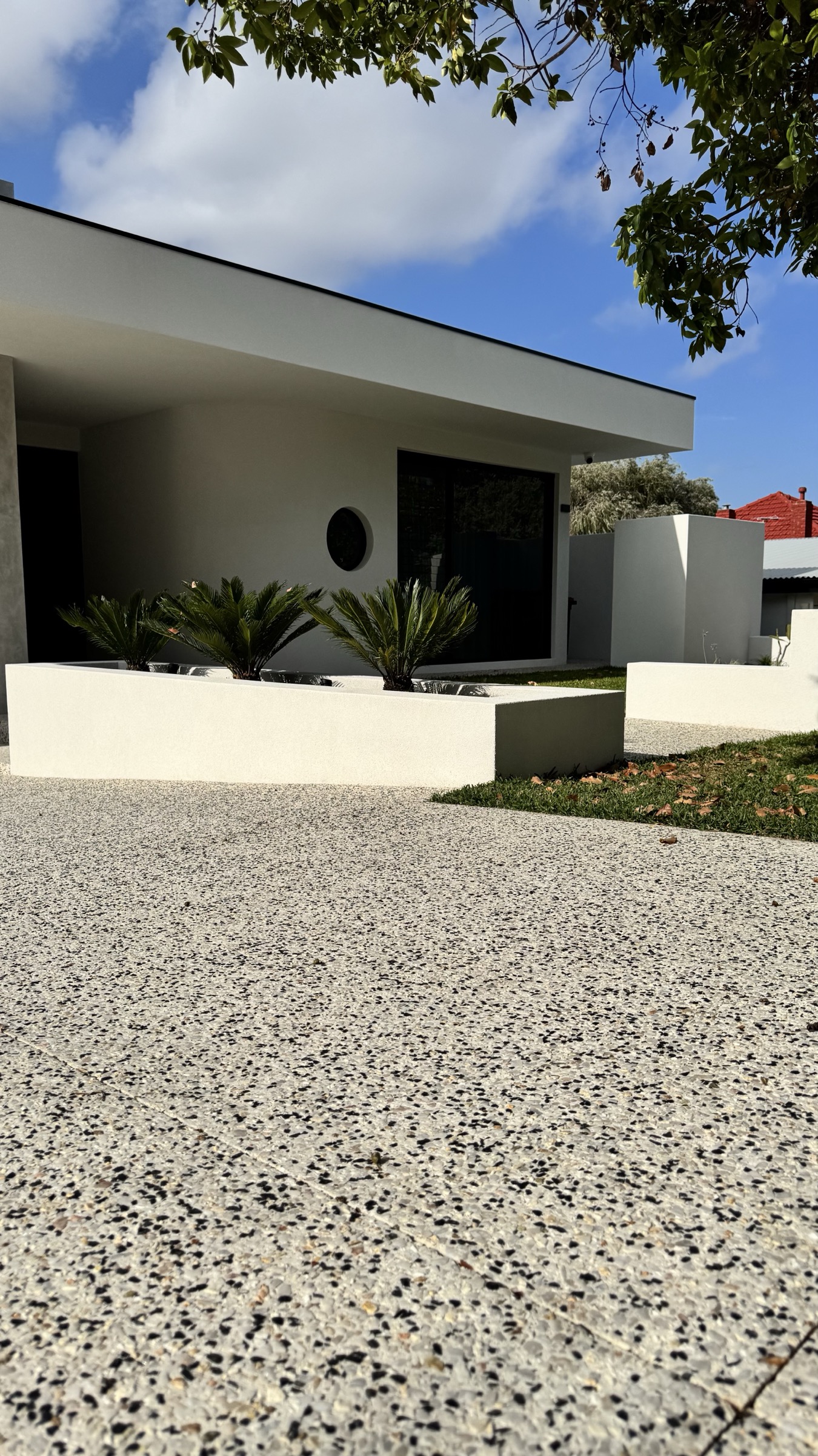 Joondanna residence entry framed by white walls and established trees