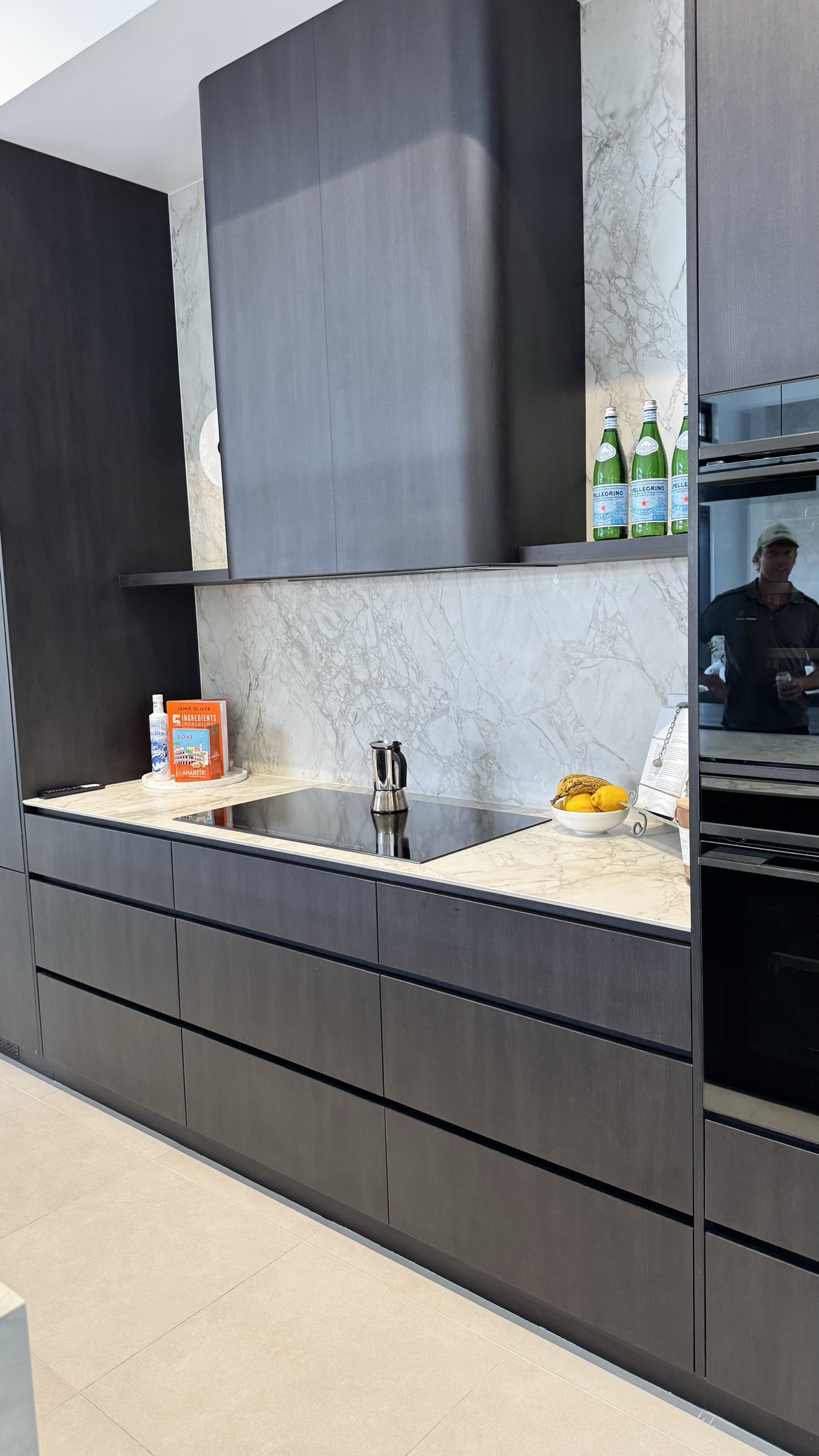 Dark timber kitchen cabinetry with softly veined stone