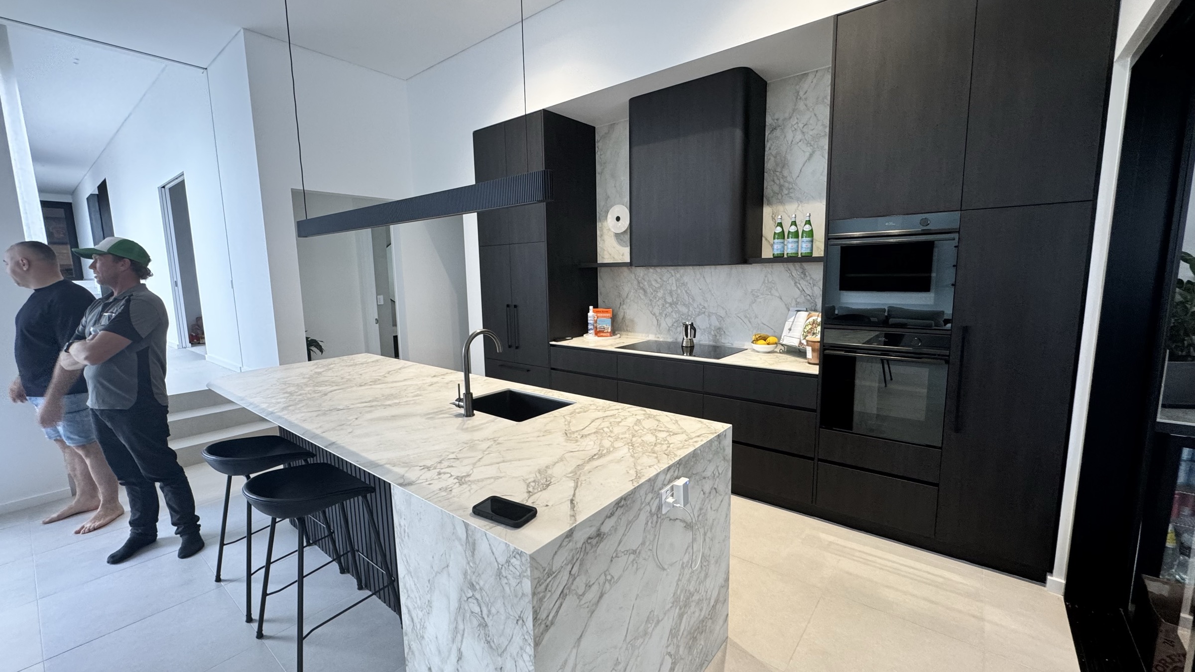 Joondanna kitchen with monolithic stone island and black cabinetry