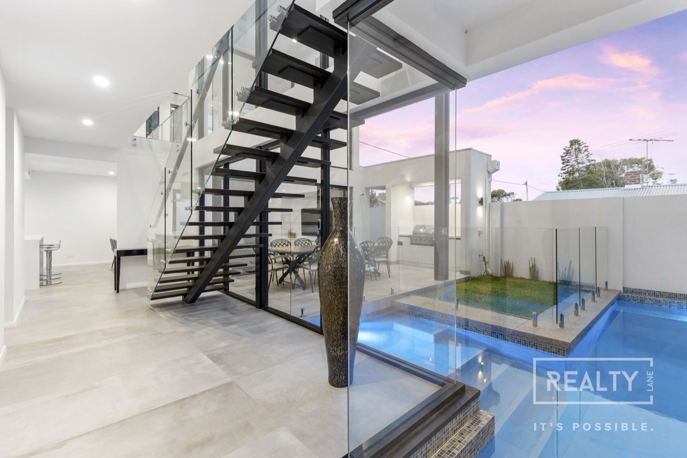 Open staircase overlooking the courtyard pool at Marine Terrace