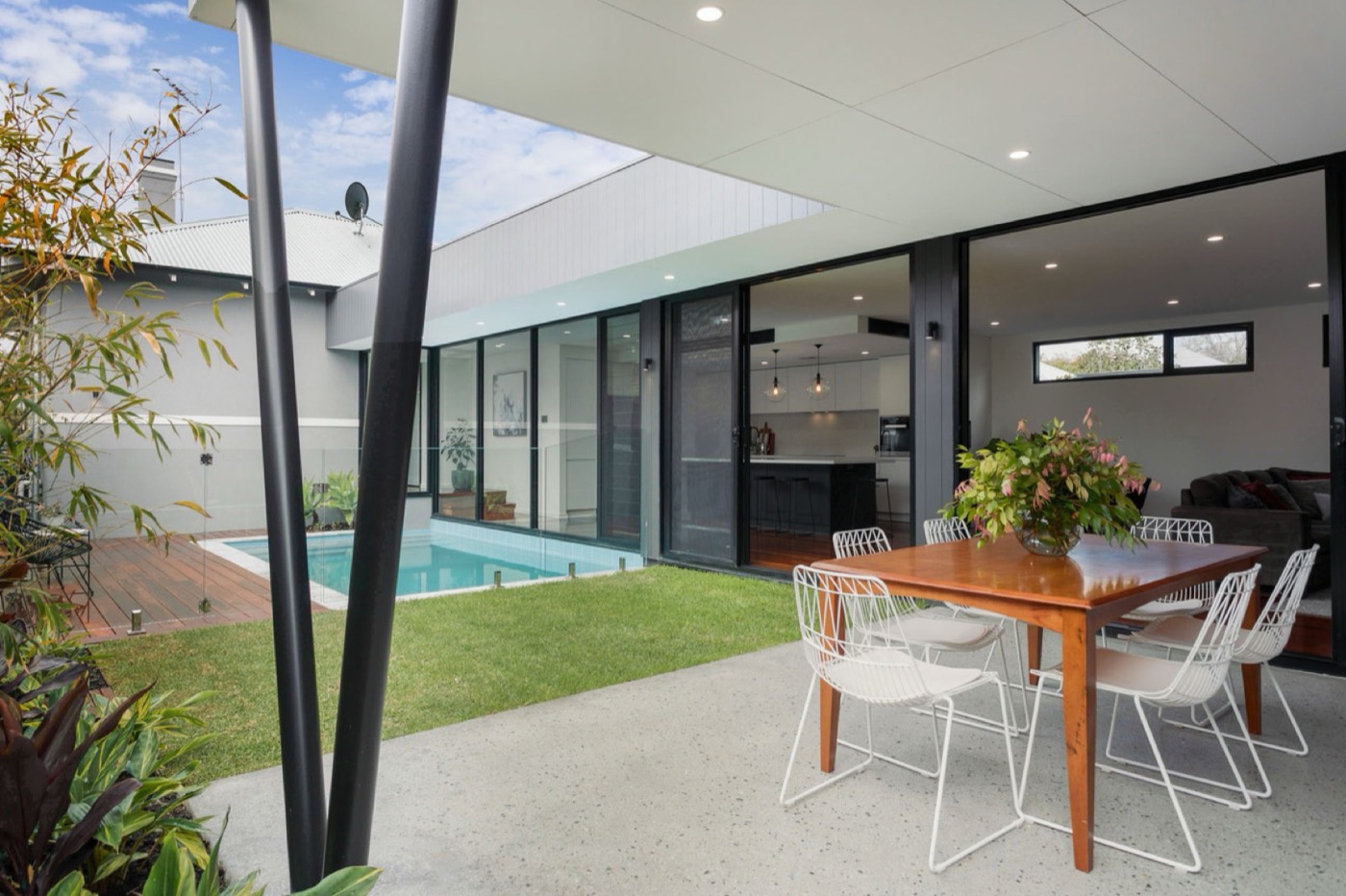Covered outdoor dining space overlooking the courtyard pool
