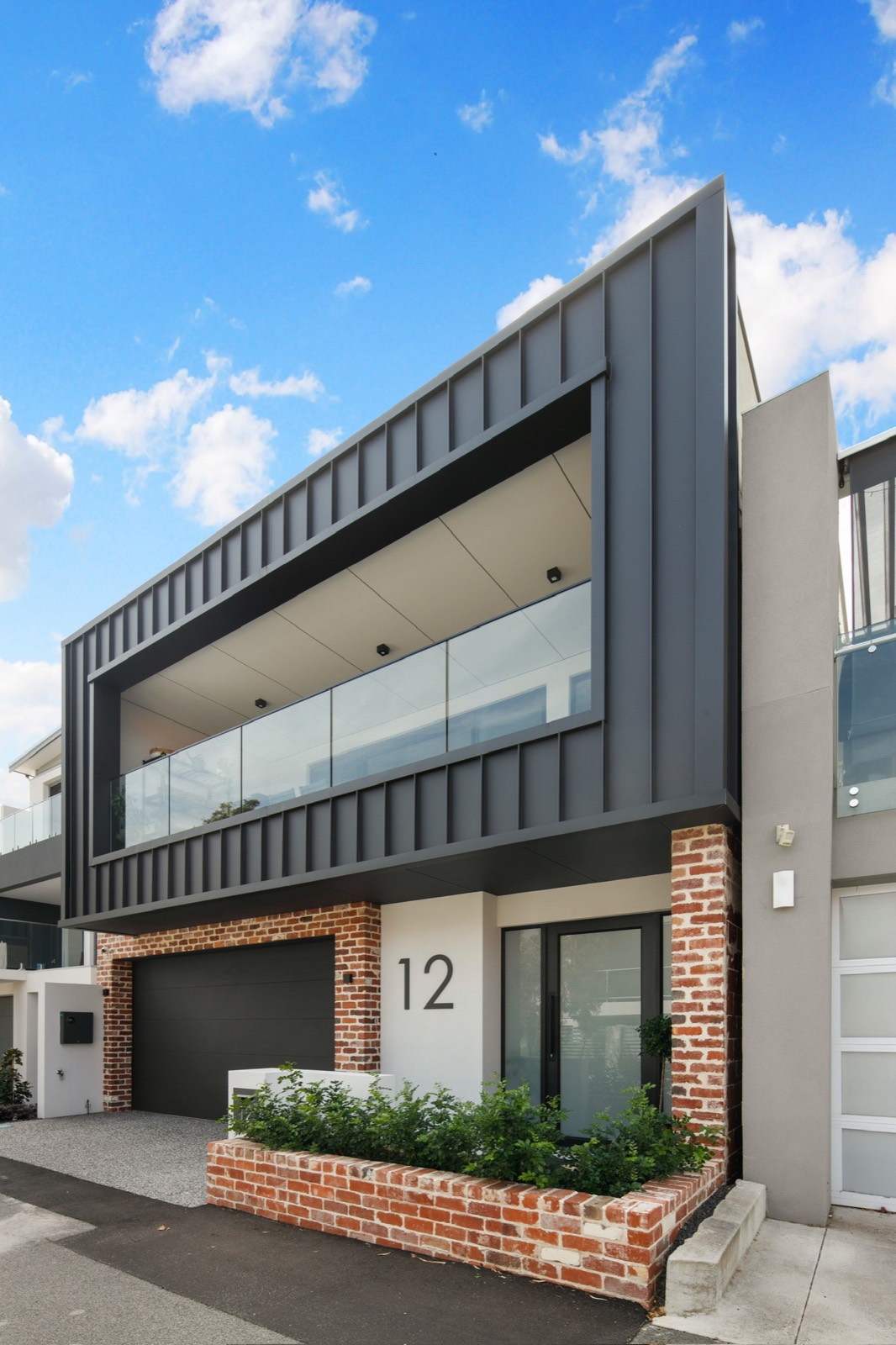 Nova Lane street facade with black steel cladding and brickwork