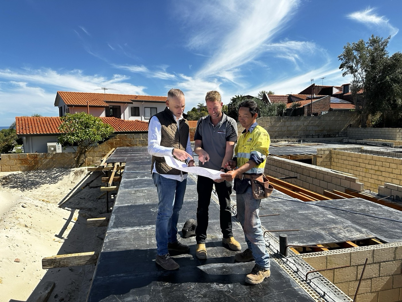 Dorian Morelli reviewing plans with the construction team on site