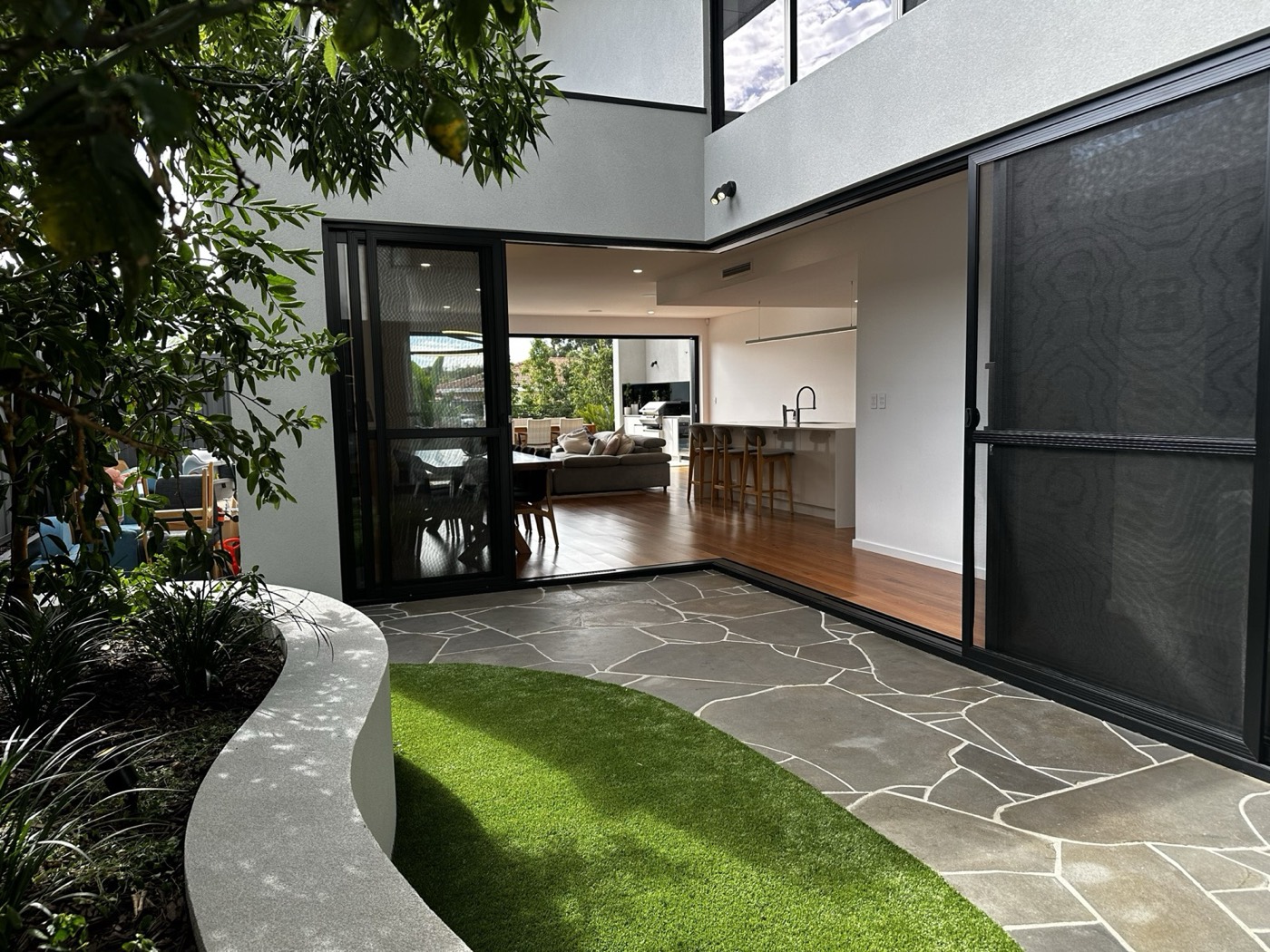 Wasley Street courtyard looking into a light-filled kitchen and living room