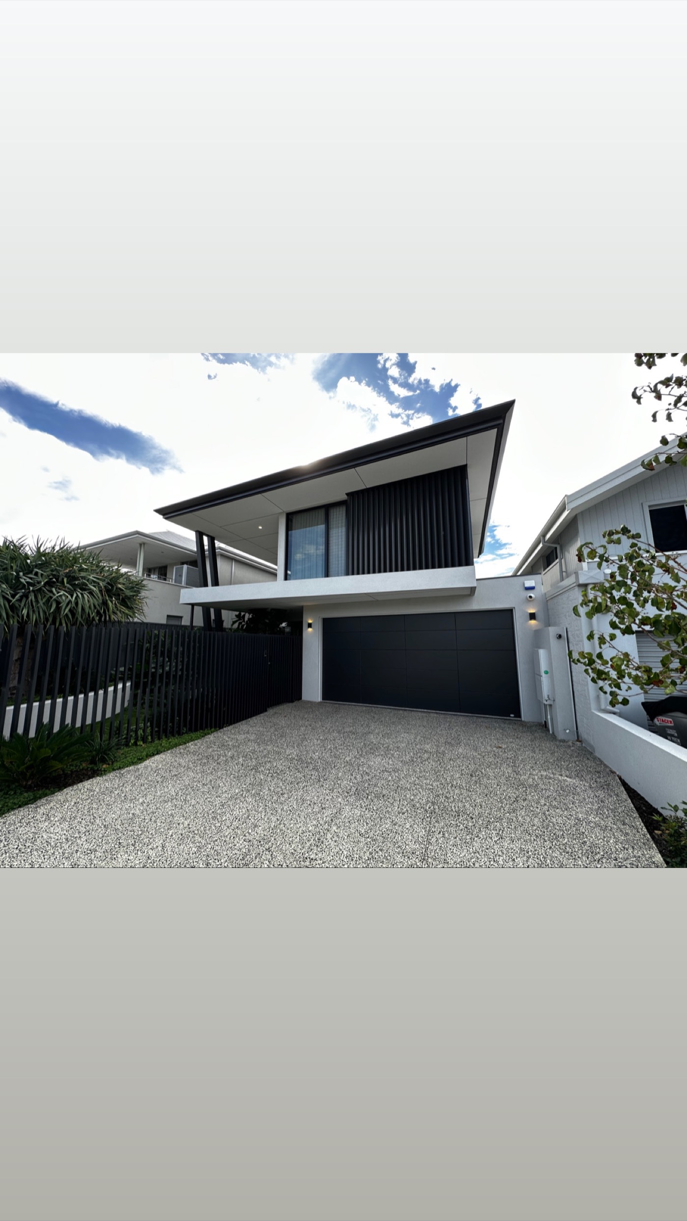 Wasley Street North Perth residence with a sweeping roofline and black screened facade