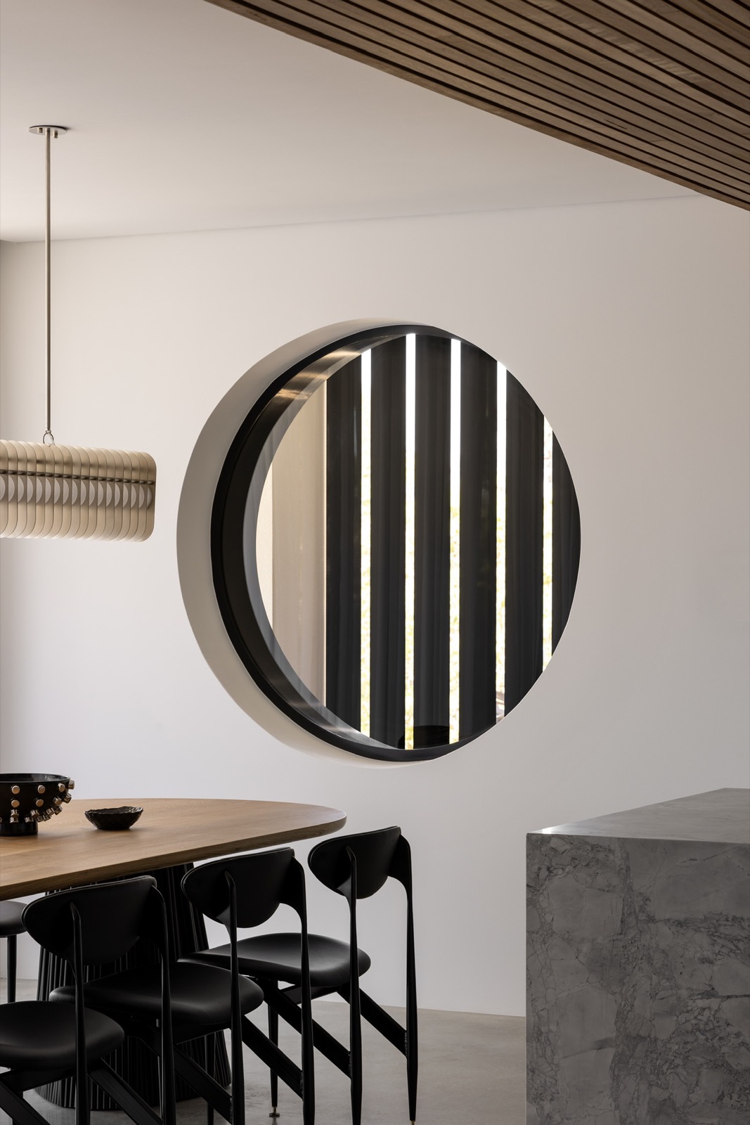 Circular opening and black blades within the Woodlands dining area