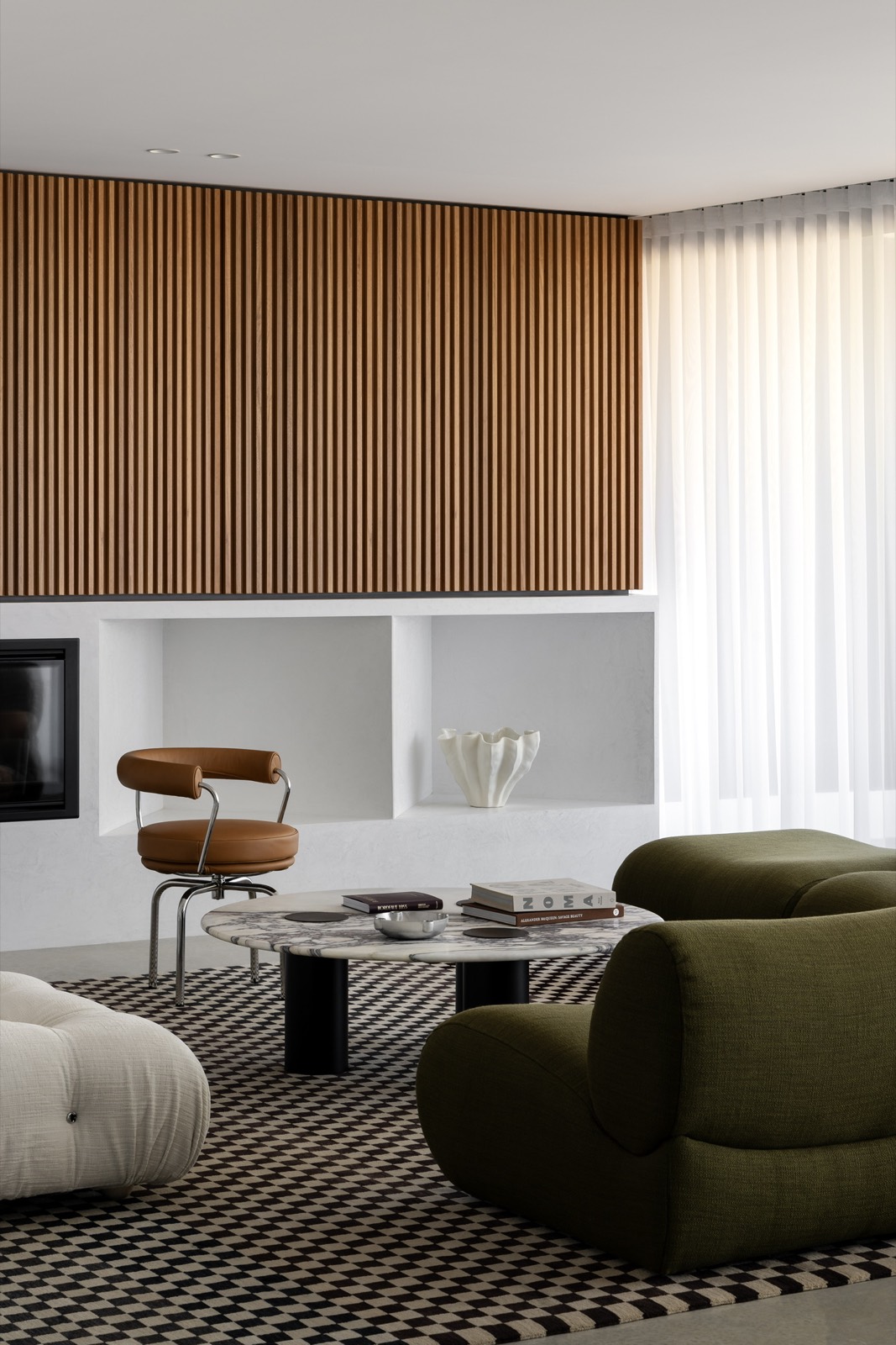 Woodlands living room with timber slatted fireplace wall